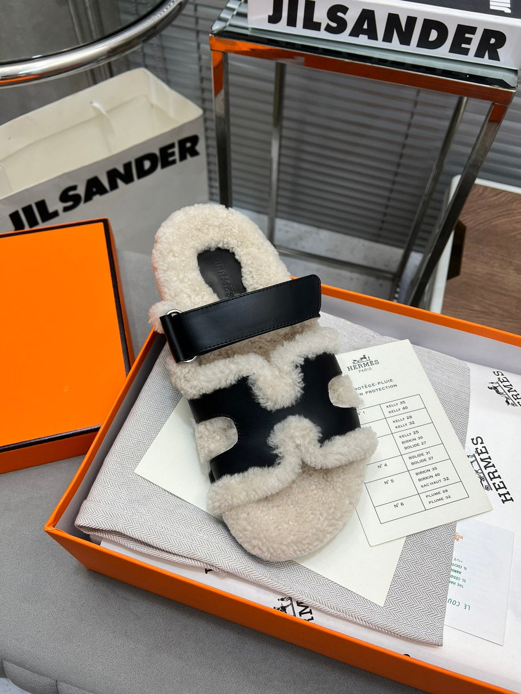 Hermes Chypre Slippers in Beige Lamb Wool and Black Calfskin