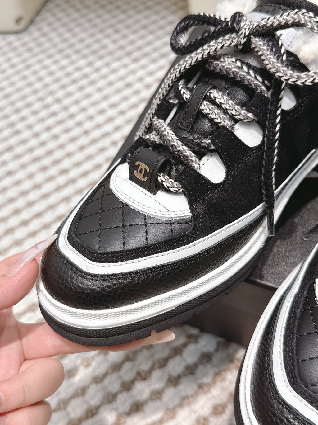 Chanel 25S Thick-Sole Sneakers in Black and White Calfskin with Fur Lining