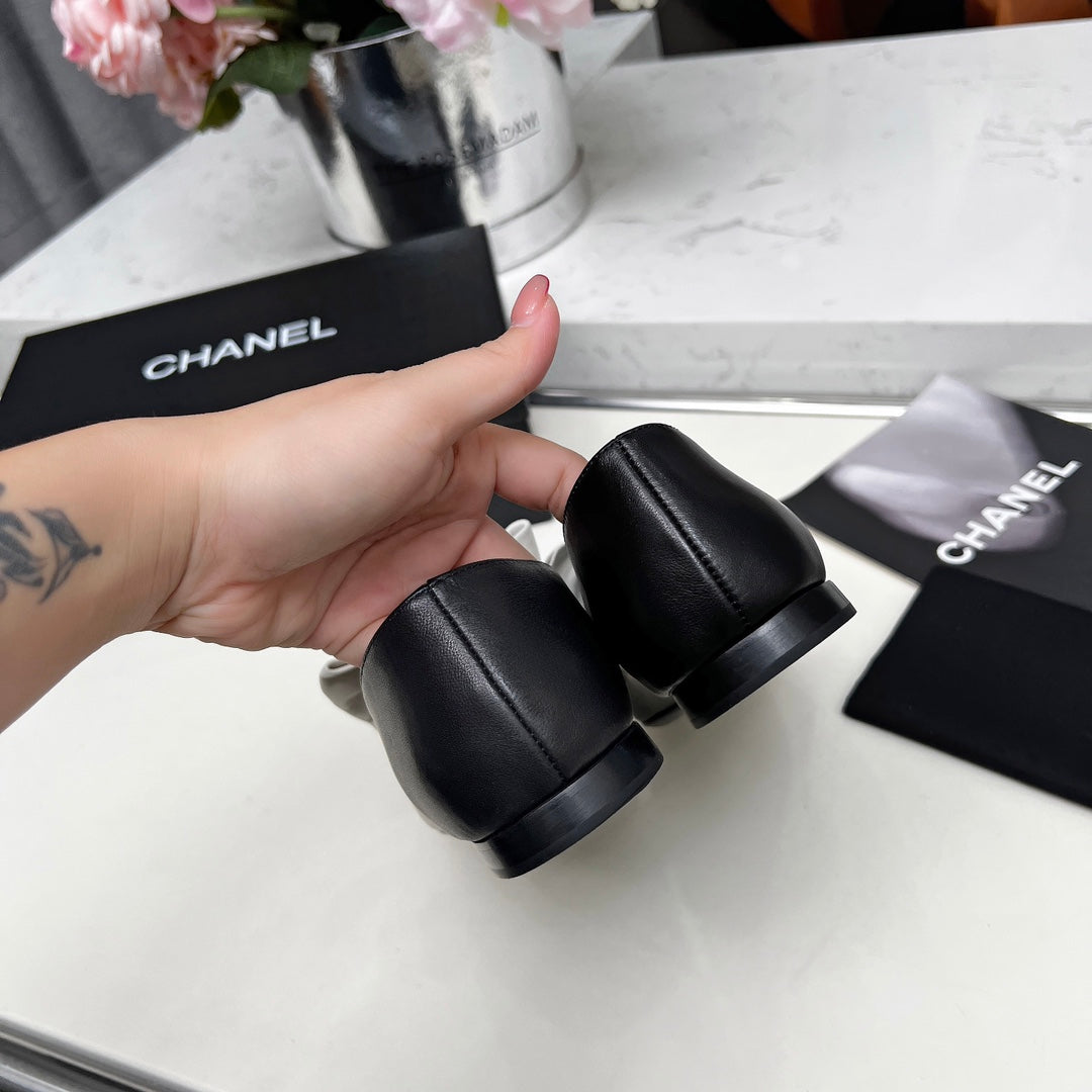 Chanel 25S Mary Janes in Black Calfskin with White Bow Gold Hardware