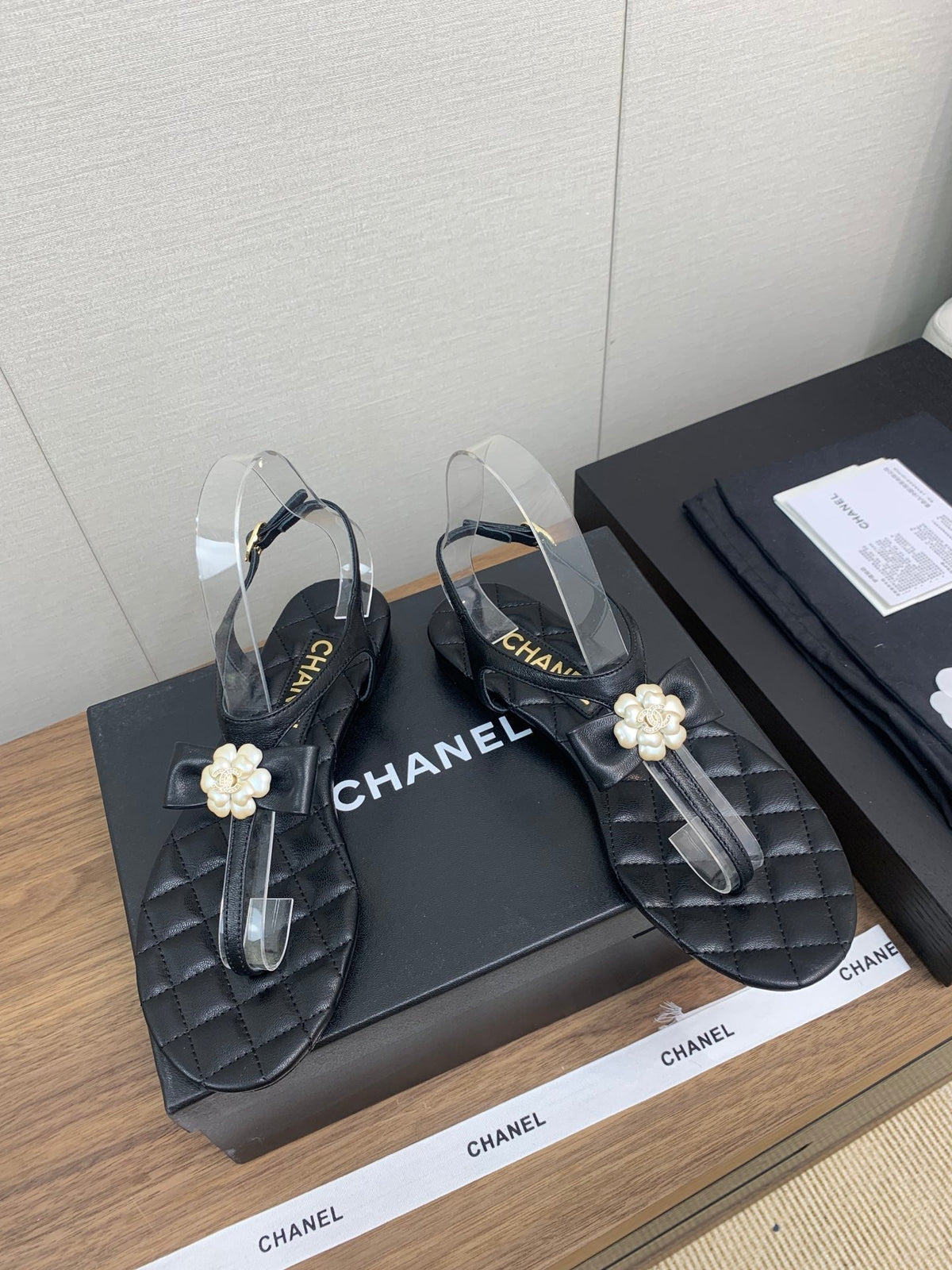 Chanel Thong Sandal in Black Lambskin with Pearl Flower